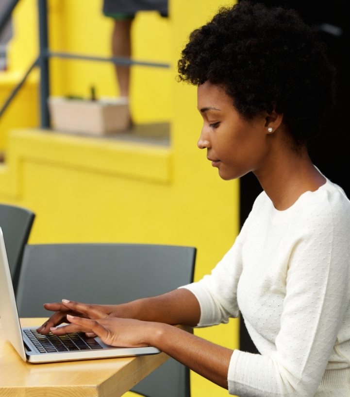 attractive-young-woman-using-laptop-outside-P9RLFGU.jpg